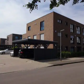 Mehrfamilienhaus (MFH) mit Parkplätzen unter Carports, moderne Architektur, Backsteinfassade, Wohngebäude