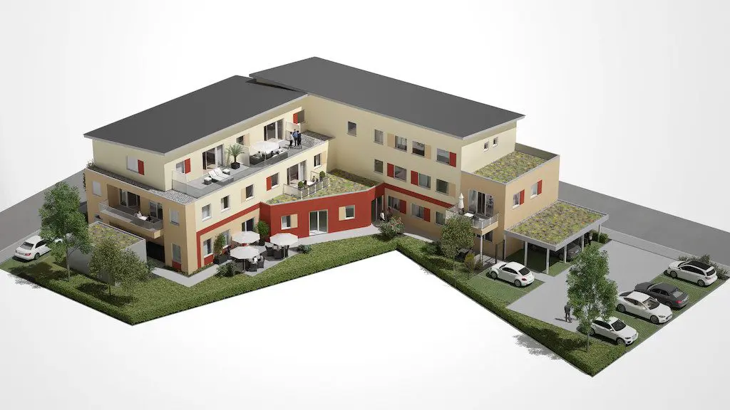 Vogelperspektive auf eine moderne Wohnanlage: Mehrfamilienhaus mit begrünten Dächern, Balkonen und PKW-Stellplätzen.