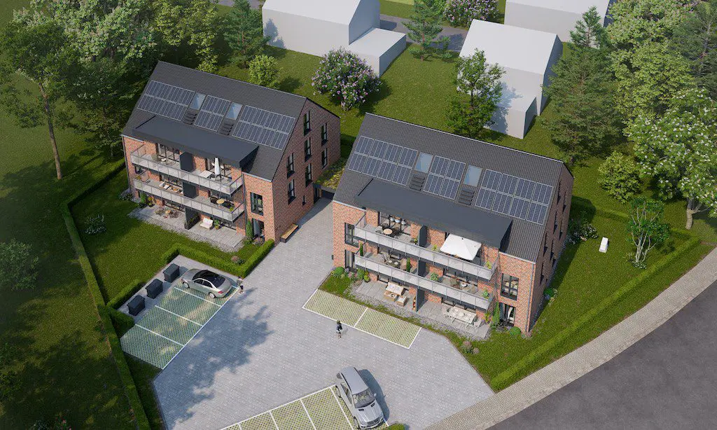 Vogelperspektive: Mehrfamilienhäuser mit Solaranlagen und Balkonen, umgeben von Grünflächen. Projekt Lengerich.